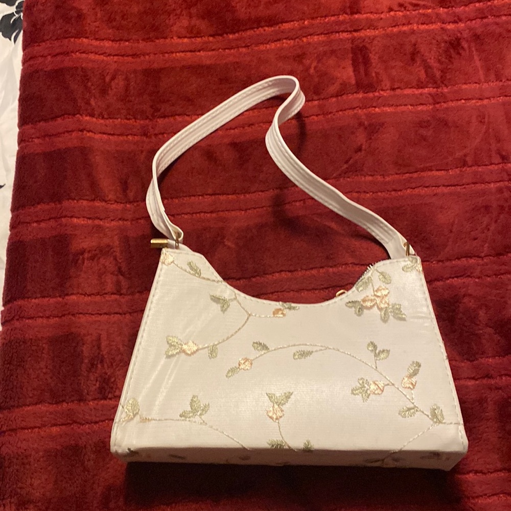 Small white purse with flower designs